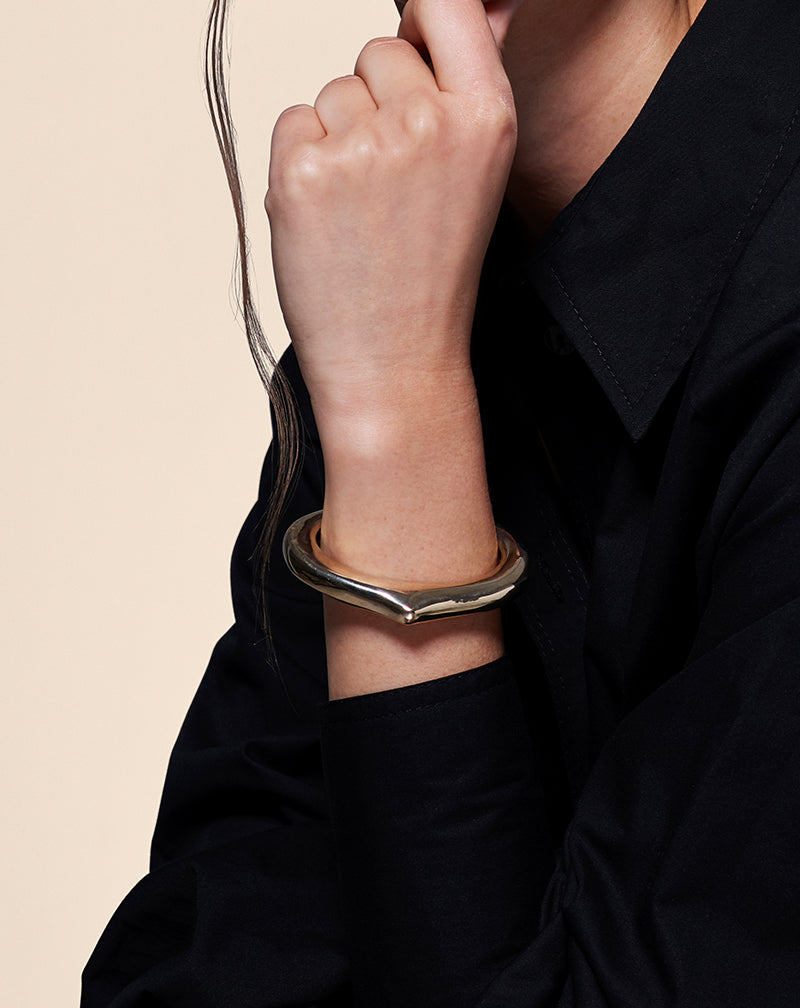 Model in black wearing a Heritage Cuff