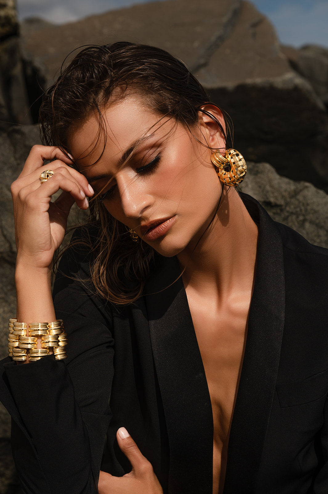 Model in black wearing Woven Frontal Hoop Earring with matching bracelet