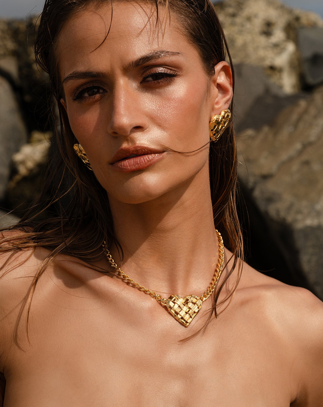 Model wearing Woven Heart Necklace with matching earrings