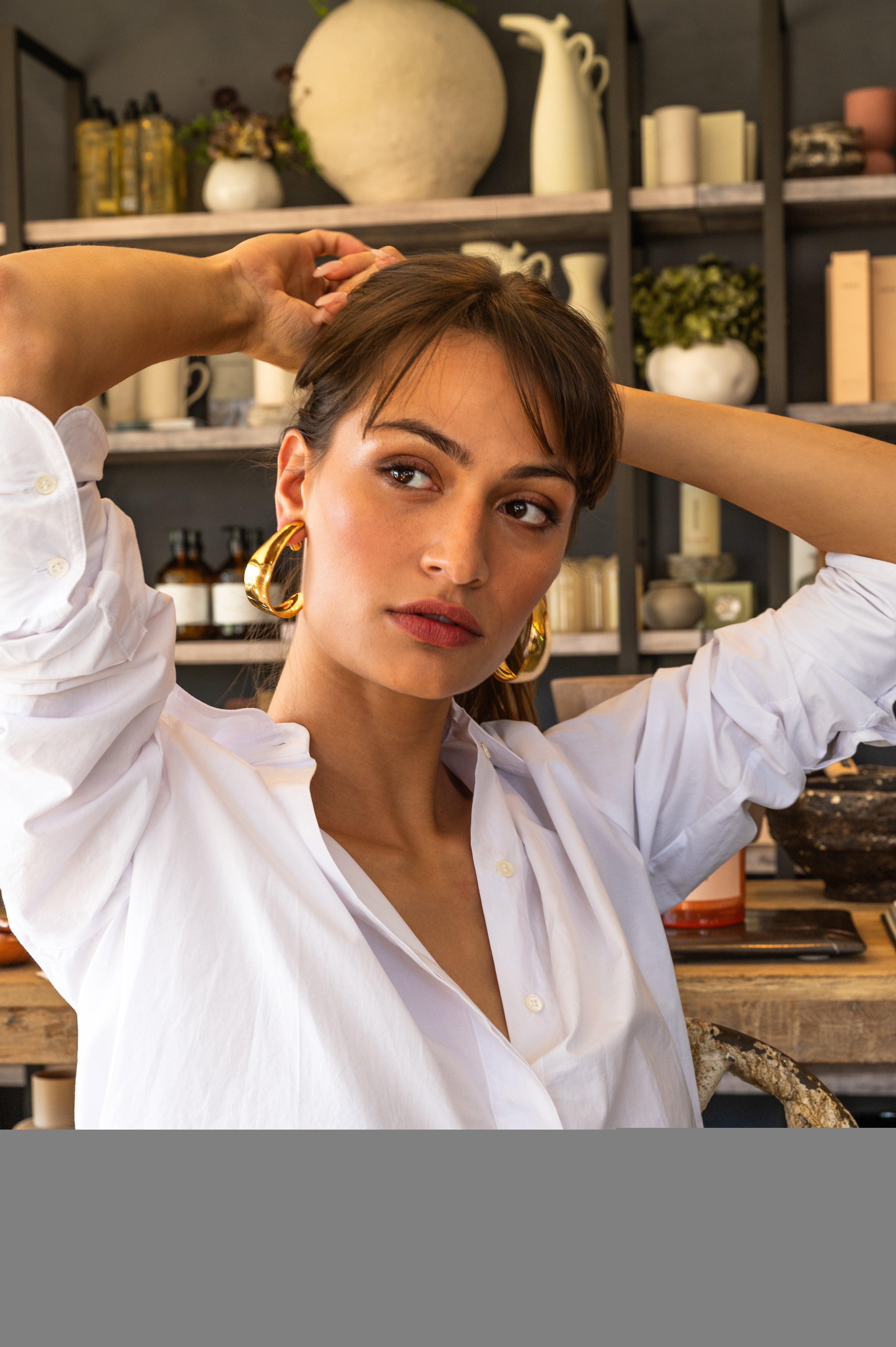 Model in white wearing Petal Earrings