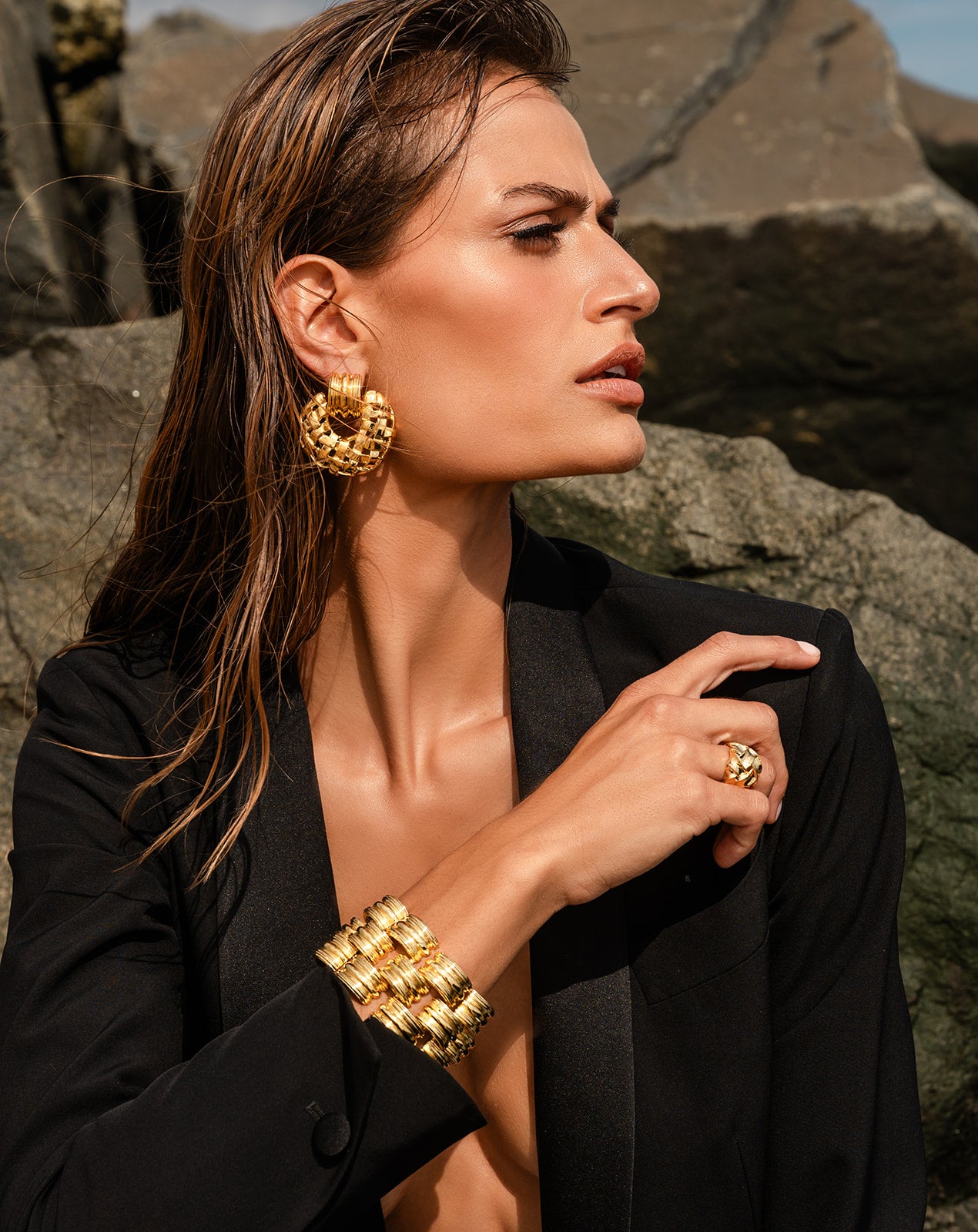 Model in a black suit wearing Deco Bracelet with matching accessories