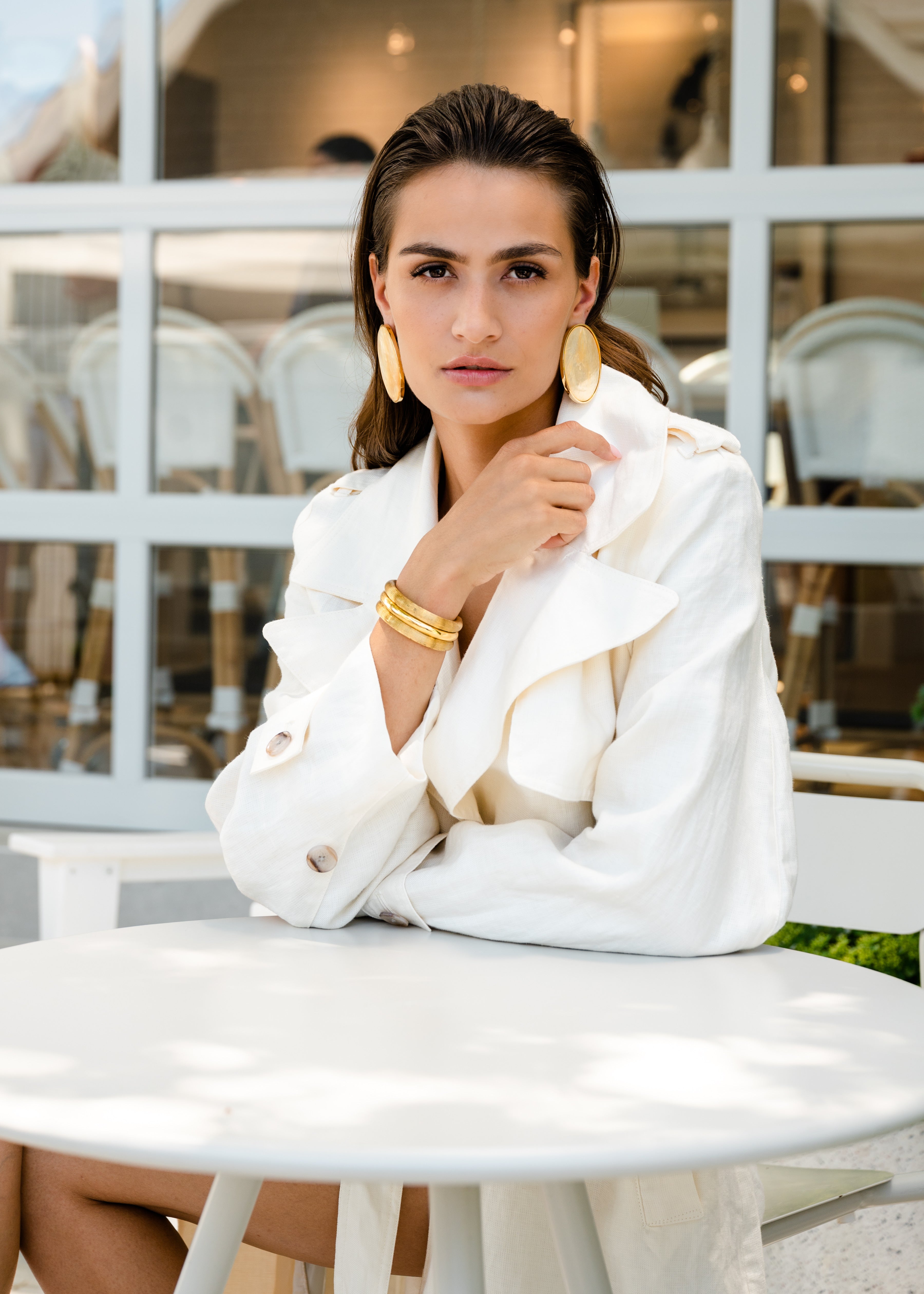 Woman wearing Bezel Set Shell Earring and Triple Cuff Bracelet