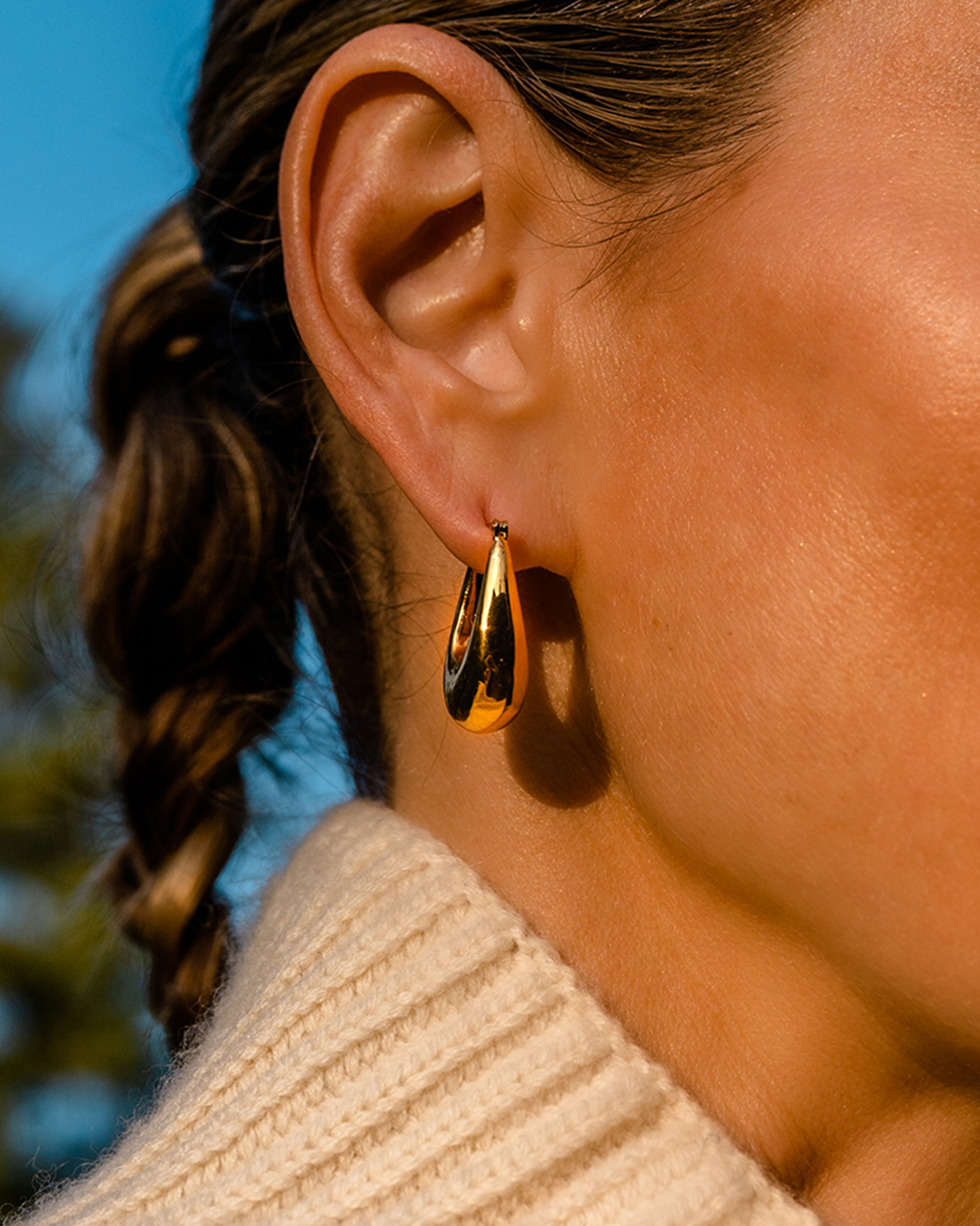 Close-up of someone's ear wearing Thick Hoop - 14k Gold Plated