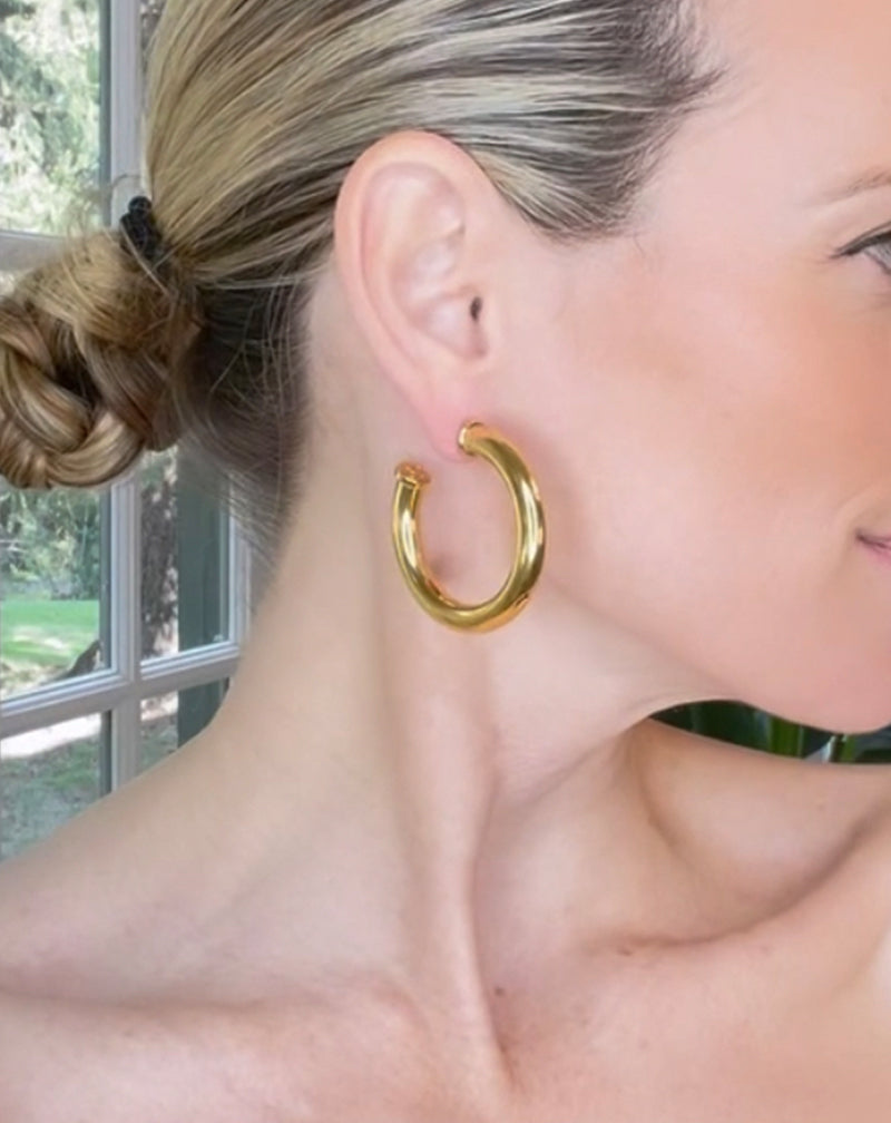 Blonde woman wearing Medium Hoop Earring in gold