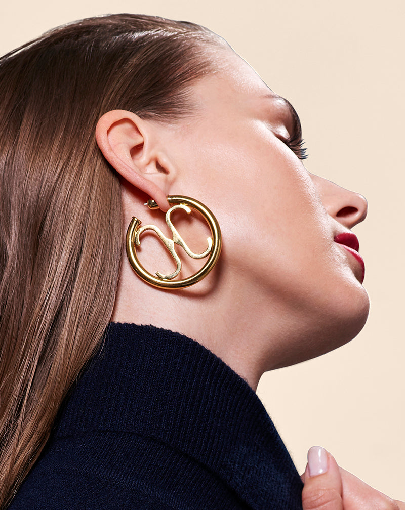 Brunette model wearing CC Logo Hoop Earrings